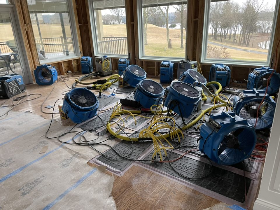 industrial air movers used in water damage restoration after flood damage in residential home